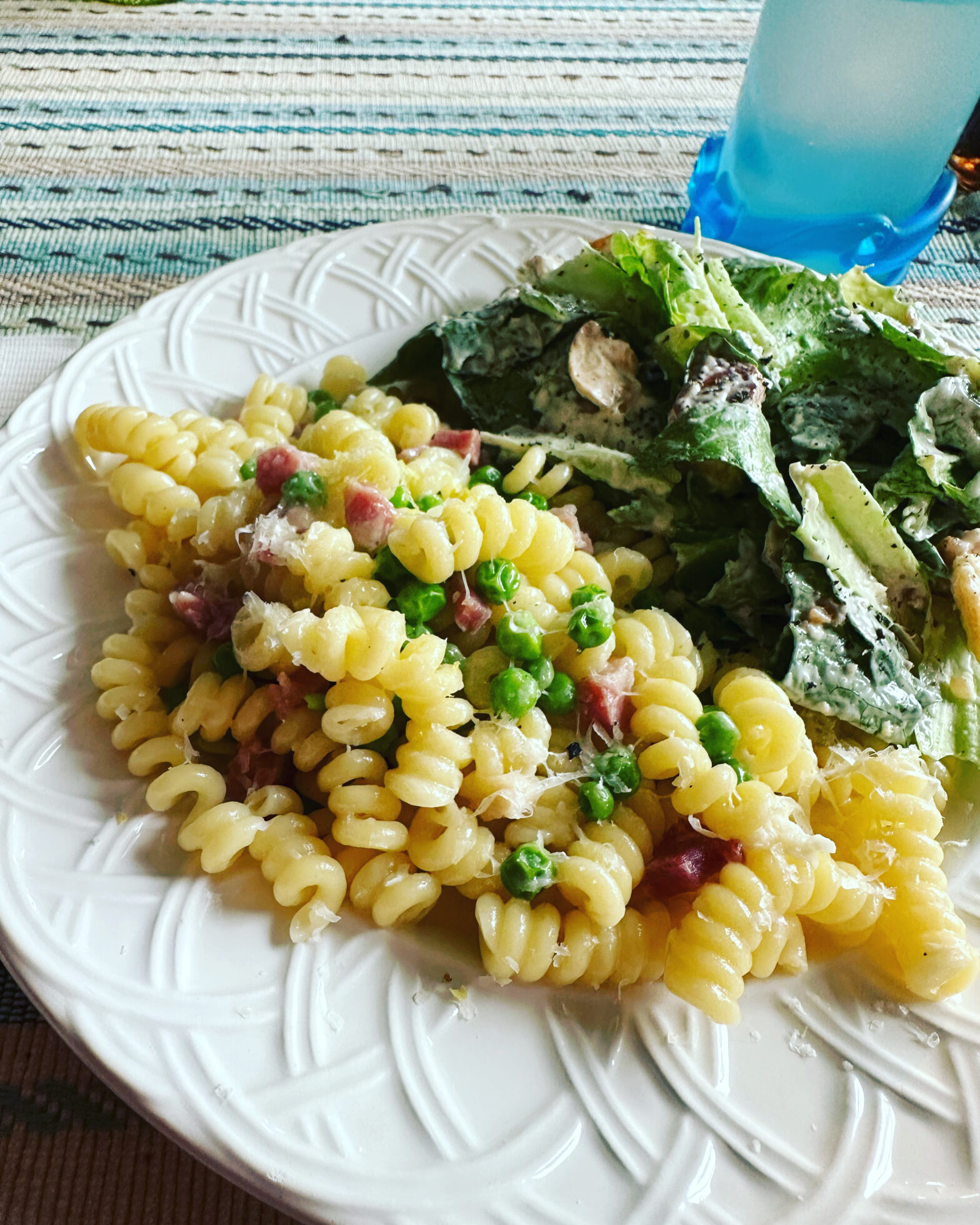 plate of pasta with ham and peas